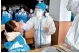  ??  ?? A medical worker in a protective suit collects a swab sample from a middle school student during a mass nucleic acid testing following a recent COVID-19 outbreak in Xingtai