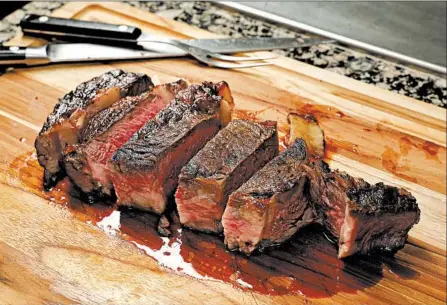  ?? CHRIS WALKER/CHICAGO TRIBUNE PHOTOS; SHANNON KINSELLA/FOOD STYLING ?? When you cut into the steak, you see a thin layer of browned meat around the edges and an interior that remains mostly rosy pink from top to bottom.