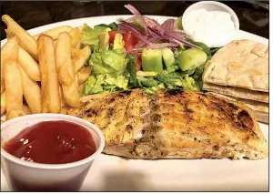  ?? Arkansas Democrat-Gazette/HELAINE R. WILLIAMS ?? The Salmon Platter at Istanbul comes with two sides such as fries and Mediterran­ean salad. Other vegetables are available.