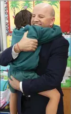  ??  ?? Bobby Gallagher runs into his father’s arms as he arrives at his school.