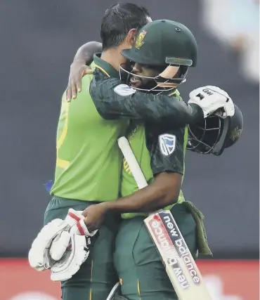  ??  ?? 0 South Africa’s Quinton de Kock, left, celebrates with Temba Bavuma after scoring a century.