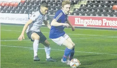  ?? John Rooney ?? Widnes FC defender River Humphreys closes down City of Liverpool player Tom Peterson during Monday evening’s cup clash at the Select Security Stadium.