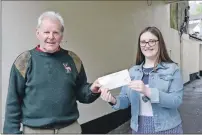  ?? Photograph: Iain Ferguson The Write Image. ?? James Kennedy of Fort William Town Team receives £100 from Lochaber Times’ reporter Ellie Forbes for the work he did to Cinema Lane.