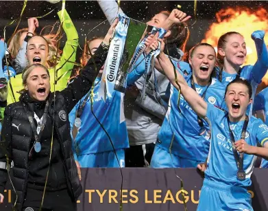  ?? GETTY IMAGES ?? Lift-off: Steph Houghton (left) and Ellen White hoist the League Cup after City’s win