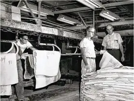  ?? BEVAN & ASSOCIATES ?? Workers at Goodyear Tire & Rubber Co. handled uncured raw rubber that was dusted with talc, or soapstone, to prevent the uncured rubber from sticking to machinery or other slabs of rubber.