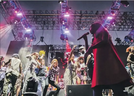  ?? Photograph­s by Maria Alejandra Cardona Los Angeles Times ?? SANTIGOLD brings her electro-dub sounds to the Music Tastes Good festival in Long Beach on Saturday. Fans dance along — she’d invited them up to the stage.