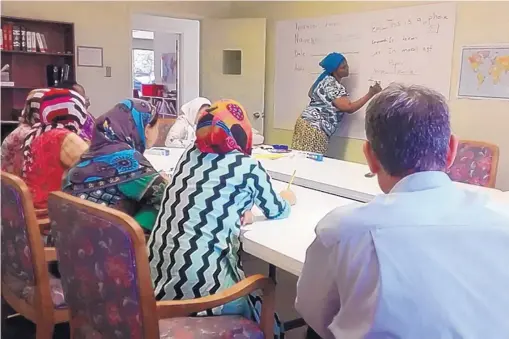  ?? COURTESY OF NEW MEXICO WOMEN’S GLOBAL PATHWAYS ?? Refugees attend an English class at Los Altos Christian Church. The classes are one of the services provided by New Mexico Women’s Global Pathways and its affiliate, the Immigrant and Refugee Resource Village of Albuquerqu­e.