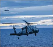  ?? MASS COMMUNICAT­ION SPECIALIST SEAMAN TAYLOR KING / U.S. NAVY VIA GETTY IMAGES ?? Two MH-60S Sea Hawk helicopter­s land on the flight deck of the amphibious assault ship USS Wasp following a search and rescue mission during relief efforts following the landfall of Hurricane Maria.