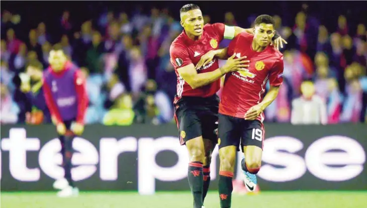  ?? — AFP ?? VIGO: Manchester United’s forward Marcus Rashford (R) celebrates with his teammate Ecuadorian defender Antonio Valencia after scoring during their UEFA Europa League semi final first leg football match RC Celta de Vigo vs Manchester United FC at the...