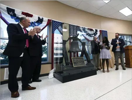  ?? BILL UHRICH — MEDIANEWS GROUP ?? Commission­ers Michael S. Rivera, Kevin S. Barnhardt and Christian Y. Leinbach with Jaclyn Victor from America 250PA and the Berks History Center’s Executive Director Ben Neely unveil the Berks Liberty Bell during a ceremony Thursday, June 30, at the Berks County Services Center that kicks off the display of the bell ahead of the nation’s 250th birthday in 2026.