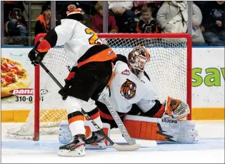  ?? NEWS FILE PHOTO ?? Medicine Hat Tigers goaltender Garin Bjorklund stops a between-the-legs shot from Brett Kemp during the team’s annual skills competitio­n on Jan. 16, 2020. Upon receiving the OK from Alberta Health, the Tigers will start play in the all-Alberta Central Division on Feb. 26.