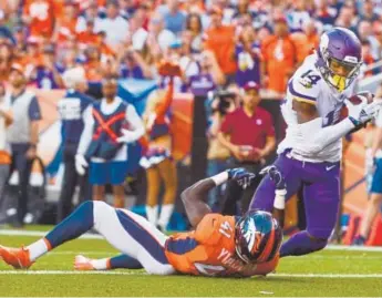  ?? Shaban Athuman, The Denver Post ?? Minnesota Vikings wide receiver Stefon Diggs scores on a touchdown pass from Kirk Cousins on Saturday night as he is defended by Broncos cornerback Isaac Yiadom.