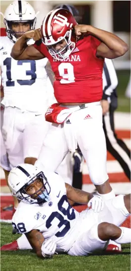  ?? JOE ROBBINS/ GETTY IMAGES ?? Michael Penix Jr. passed for a touchdown in overtime before running for the decisive two- point conversion as Indiana upset Penn State.