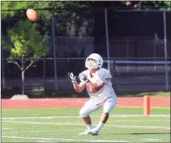  ?? Bob Luckey Jr. / Hearst Connecticu­t Media ?? Greenwich’s Tysen Comizio receives the opening kickoff during the annual Red vs. White scrimmage at Cardinal Stadium in Greenwich in 2018.