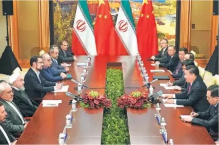  ?? WAN QUAN / FOR CHINA DAILY ?? President Xi Jinping meets Iranian President Hassan Rouhani on the sidelines of the 18th Shanghai Co-operation Organisati­on Summit in Qingdao, Shandong province, on June 10.