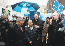  ?? Julio Cortez / Associated Press ?? Sen. Bob Menendez, D-N.J. (left), and Cardinal Joseph Tobin (center right) stand with Catalino Guerrero in Newark, N.J.