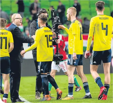  ??  ?? Alex Mcleish congratula­tes his players in Budapest following their 1-0 win over Hungary last Tuesday