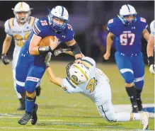  ?? RICK KINTZEL/THE MORNING CALL ?? Southern Lehigh fullback Hunter Hughes (38) gives a stiff-arm to Notre Dame-Green Pond’s Michael Irving on Friday night.