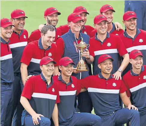  ?? ?? WINNERS: The victorious US team celebratin­g with the Ryder Cup after blowing away Europe at Whistling Straits.