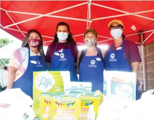  ??  ?? Junior Auxilary of Starkville members Nikki Robinson, Lauren Langley, Emily Camp and Haley Todd pose with some of the school supplies collected by the organizati­on during its annual Stuff the Bus drive. (Photo by Charlie benton, SDN)