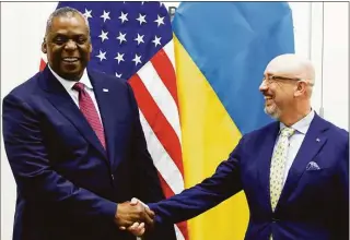  ?? Yves Herman / Associated Press ?? U.S. Defense Secretary Lloyd Austin, left, greets Ukraine's Defense Minister Oleksii Reznikov ahead of a NATO defense ministers meeting at NATO headquarte­rs in Brussels on Wednesday.