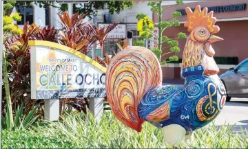  ??  ?? Decorative rooster statues painted with colorful designs and patterns welcomes visitors to Calle Ocho in the heart of Little Havana in Miami.