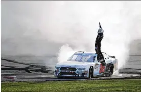  ?? MATTHEW PUTNEY / ASSOCIATED PRESS ?? Chase Briscoe stands on his car as he celebrates after winning Saturday’s NASCAR Xfinity Series race at Iowa Speedway in Newton, Iowa.