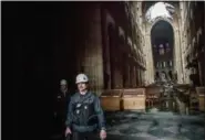  ?? CHRISTOPHE PETIT TESSON — THE ASSOCIATED PRESS ?? A man walks nside the damaged Notre Dame cathedral in Paris on Tuesday.