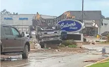  ?? AP ?? This image provided by Steven Bischer shows an upended vehicle at a Culver’s restaurant after a tornado touched down in Gaylord, Mich., May 20. The tornado killed two people.