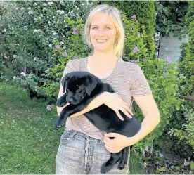  ?? ?? Lindsay Macdonald is shown with Arrow, a pure-bred Labrador Retriever puppy arriving at her new home in Halifax in September 2022 from Everwood Labs.
