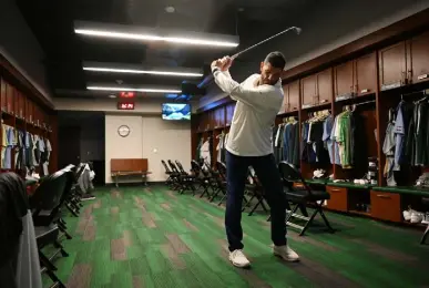  ?? ?? Colorado State football coach Jay Norvell takes 10 minutes to work on his golf swing in the coaches locker room at Canvas Stadium last week. He said it helps him think.