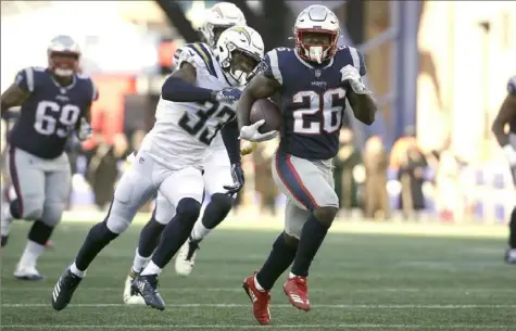  ?? Associated Press ?? Sony Michel runs away from Angeles Chargers free safety Derwin James in the first half of the Patriots’ 41-28 win Sunday in Los Angeles. The rookie running back ran for 129 yards and three touchdowns.