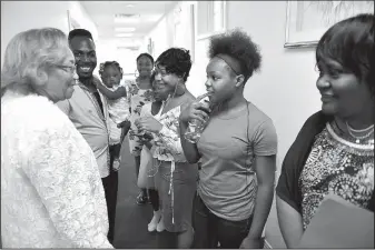  ?? The Washington Post/KATHERINE FREY ?? The Rev. Mary Fowler (left) talks with members of the youth choir before services at Mary’s Missionary Baptist Church in Washington. Choir members include (from left) choir director Mario Wilson; Rikia Wilson, 14; Dania Wilson, 9; Antia Wilson, 16; and Mia Wilson, 11; and Linda Williams.