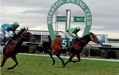  ?? PHOTO: KAVINDA HERATH/FAIRFAX NZ ?? Patrick Erin (Shankar Muniandy) wins from Revelator (Krishna Mudhoo) in the $60,000 Riverton Cup on Saturday.