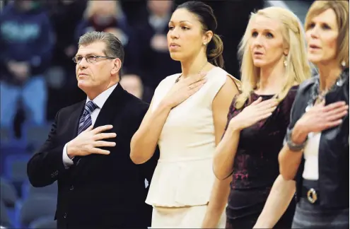  ?? Jessica Hill / Associated Press ?? UConn coach Geno Auriemma, left, stands with assistant coaches Marisa Moseley, second from left, and Shea Ralph and associate head coach Chris Dailey, right, during the national anthem before a 2015 game in Hartford.