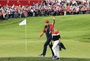  ?? Warren Little / Getty Images ?? Captain Steve Stricker of Team United States and wife Nicki Stricker celebrate the win on the 18th green during Sunday singles matches of the 43rd Ryder Cup at Whistling Straits in Wisconsin.