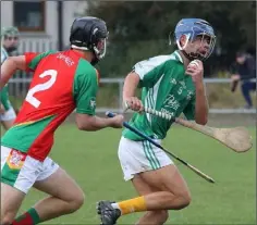 ??  ?? Darragh Canavan of Naomh Eanna tries to avoid the attention of Matthew Balfe (Rapparees).