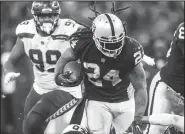  ?? BETTINA HANSEN/TRIBUNE NEWS SERVICE ?? Oakland Raiders running back Marshawn Lynch is stopped by Seattle Seahawks cornerback Shaquill Griffin and strong safety Bradley McDougald in the second half on Oct. 14 at Wembley Stadium in London, England.