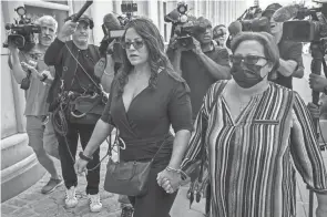  ?? JOHN MINCHILLO/AP ?? Lizzette Martinez, author of “Jane Doe #9: How I Survived R. Kelly,” left, arrives to federal court Wednesday in New York. Widespread outrage over R. Kelly’s sexual misconduct reached a crescendo after the release of several in-depth accounts of his abuse.