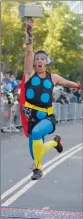  ?? PICTURE: REUTERS ?? Jacob Boyer lifts his Thor hammer while crossing the finish line during the Avengers Super Heroes Half Marathon in California.