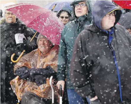  ?? PHOTOS: GREG SOUTHAM ?? Clarence Visser, 89, bundled up in a winter coat and orange poncho, has been attending the Way of the Cross event for 30 years. “It lifts my spirit,” he said.