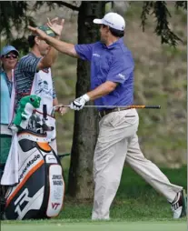  ??  ?? Johnson Wagner gives a high five to his caddie after an eagle on the 12th hole Thursday during the first round of the Greenbrier Classic in White Sulphur Springs, W.Va. Wagner finished the round at
8-under-par 62.