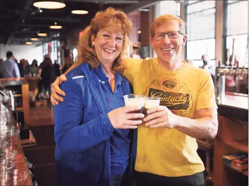  ?? Brian A. Pounds / Hearst Connecticu­t Media ?? Stratford Mayor Laura Hoydick and Two Roads Brewing company founder and CEO Brad Hittle celebrate over a cup of the brewery’s new seasonal Herzzoner beer at the brewery in Stratford on Thursday.