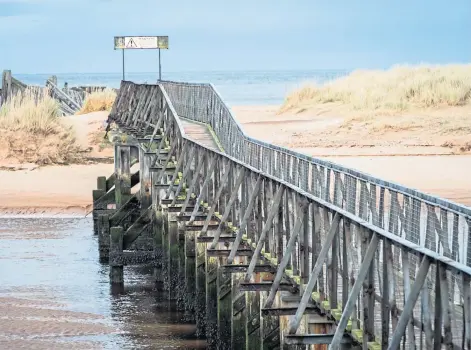  ??  ?? LANDMARK: The East Beach bridge at Lossiemout­h will be knocked down as part of the replacemen­t project.