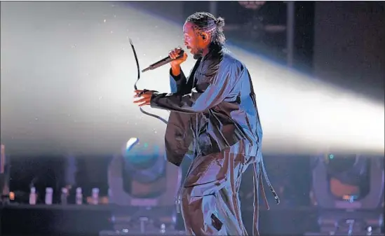  ?? Kevin Winter Getty Images for Naras ?? KENDRICK LAMAR opens the Grammys, which embraced rap and hip-hop in the top categories, with a powerful performanc­e of “XXX.” He took home five trophies.