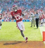  ?? [BRYAN TERRY/ THE OKLAHOMAN] ?? Oklahoma's Marvin Mims (17) scores a touchdown during the Red River Showdown against Texas Longhorns on Oct. 10 at Cotton Bowl Stadium in Dallas.