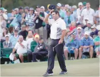  ??  ?? Patrick Reed of the US finishes the day on the 18th green during second round play of the 2018 Masters golf tournament at the Augusta National Golf Club in Augusta, Georgia, US. — Reuters