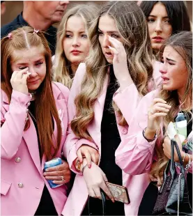  ?? ?? Tearful: T Grieving mother Cheryl Korbel holds a toy yesterday. Distressed mourners all wore pink to remember Olivia, inset left