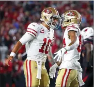  ?? RALPH FRESO – GETTY IMAGES ?? The 49ers’ Jimmy Garoppolo, left, celebrates with Kendrick Bourne after Bourne caught the second of Garropolo’s four TD passes.