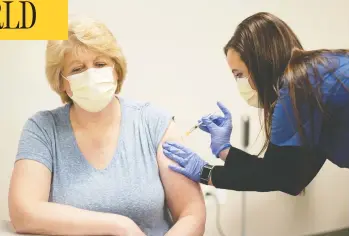  ?? JOHN MANIACI / UW HEALTH / HANDOUT VIA REUTERS ?? RN clinical staff educator Diane Mikelsons receives a mock Pfizer shot during a staff COVID-19 vaccine training session at the UW Health medical centre in Madison, Wisc., on Tuesday.